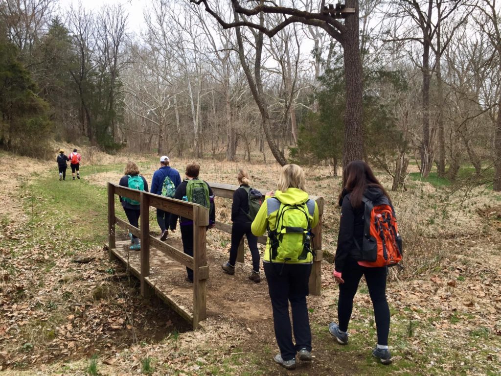 hikers crossing a bridge